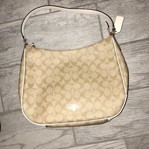 A beige coach purse. NEVER BEEN USED🎉